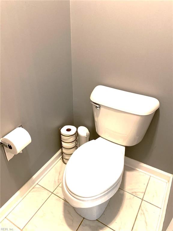 bathroom with baseboards and toilet