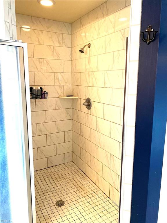 bathroom featuring recessed lighting and a shower stall