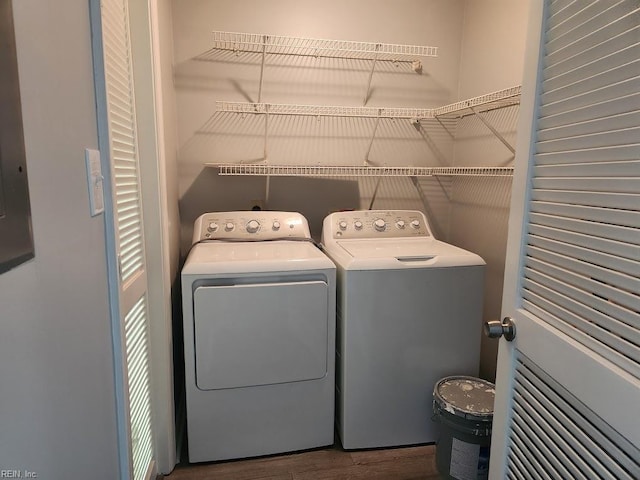 laundry area with independent washer and dryer and wood finished floors