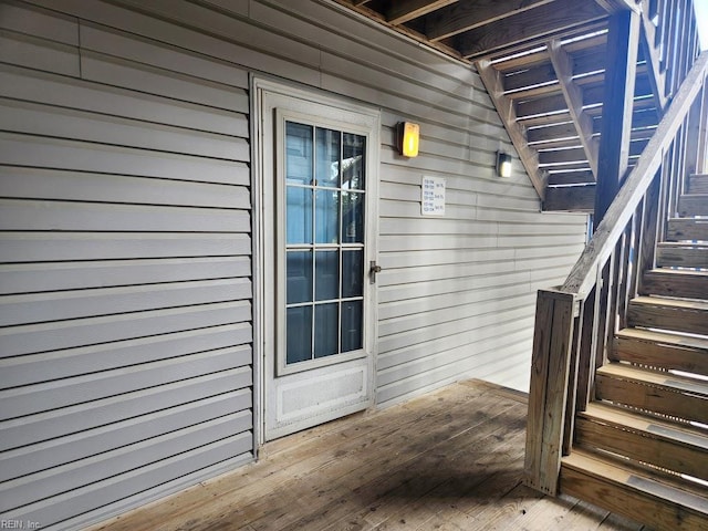 view of exterior entry with a wooden deck