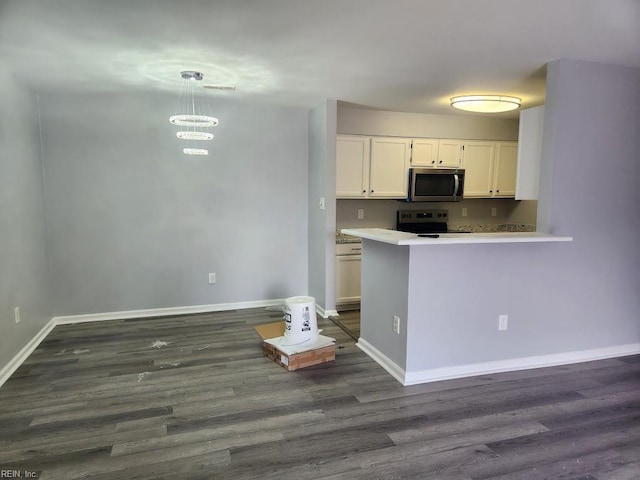 kitchen with appliances with stainless steel finishes, dark wood finished floors, light countertops, baseboards, and white cabinets