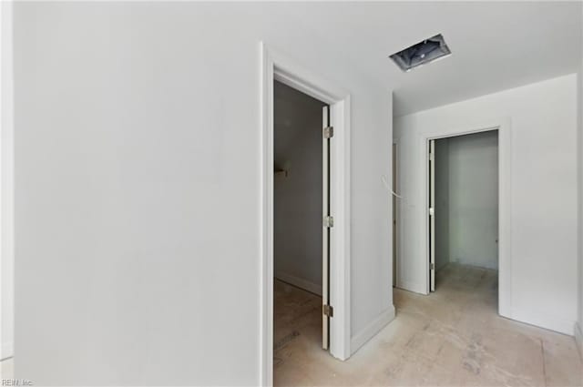 hallway featuring baseboards