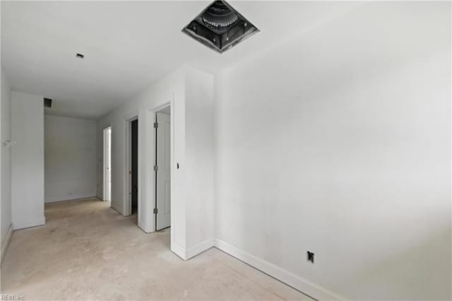 spare room with baseboards and unfinished concrete flooring