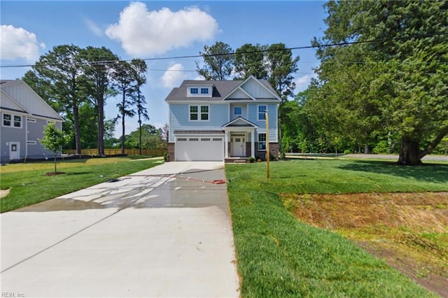 view of front of home featuring driveway, a garage, and a front lawn