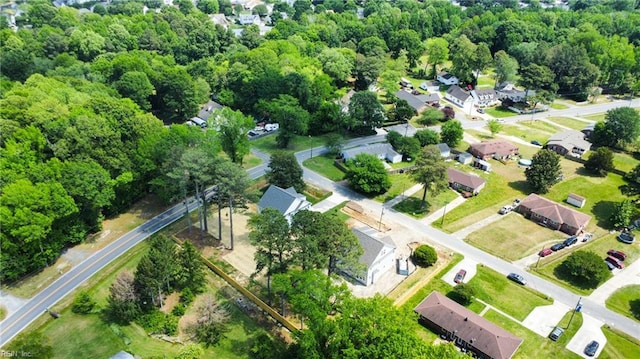 aerial view of property and surrounding area with nearby suburban area