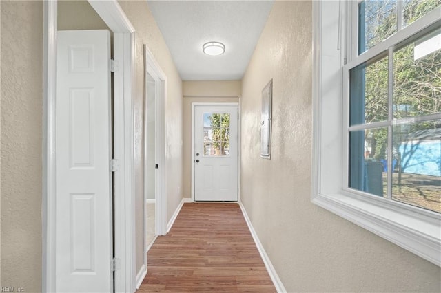 2509 Tidewater Dr, Norfolk, VA 23504 - doorway to outside featuring a textured wall, wood finished floors, and baseboards