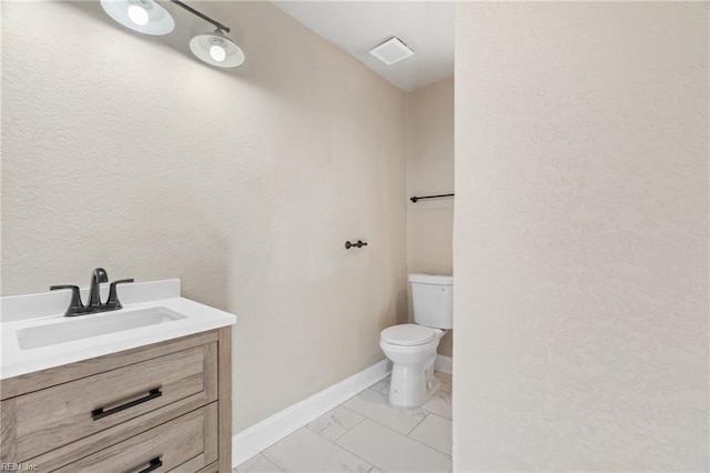 2509 Tidewater Dr, Norfolk, VA 23504 - bathroom featuring toilet, marble look tiles, vanity, and baseboards