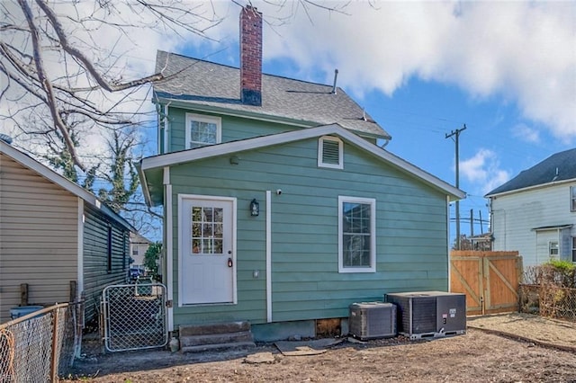 2509 Tidewater Dr, Norfolk, VA 23504 - back of property with central AC, a chimney, a gate, and entry steps