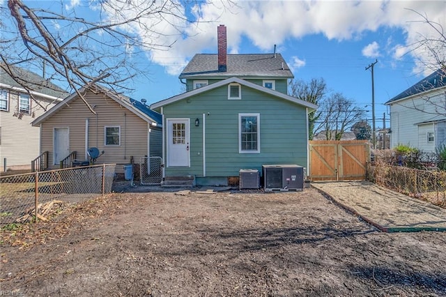2509 Tidewater Dr, Norfolk, VA 23504 - rear view of house featuring a gate, cooling unit, and a chimney
