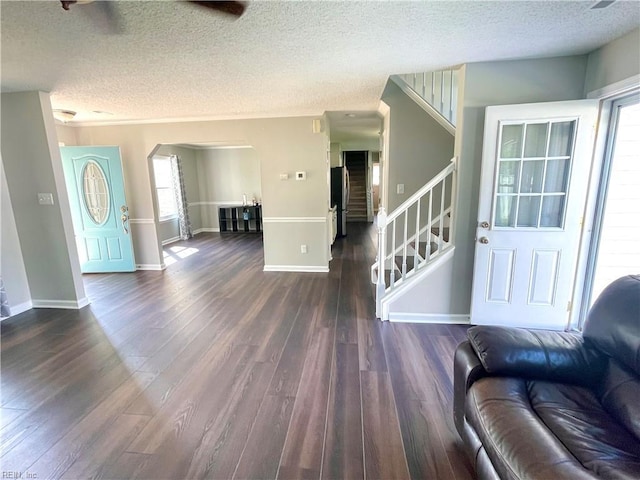 1304 Fernham Ln, Chesapeake, VA 23322 - unfurnished living room featuring stairs, arched walkways, and a textured ceiling