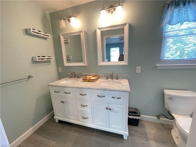 1304 Fernham Ln, Chesapeake, VA 23322 - bathroom with a sink, baseboards, toilet, and double vanity