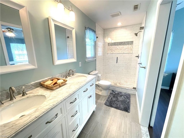 1304 Fernham Ln, Chesapeake, VA 23322 - bathroom featuring toilet, a ceiling fan, a sink, and a stall shower