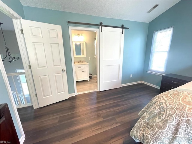 1304 Fernham Ln, Chesapeake, VA 23322 - bedroom featuring a barn door, baseboards, lofted ceiling, dark wood-type flooring, and visible vents