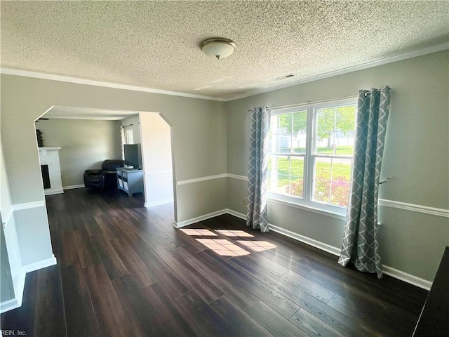 1304 Fernham Ln, Chesapeake, VA 23322 - empty room featuring crown molding, arched walkways, dark wood finished floors, and a textured ceiling