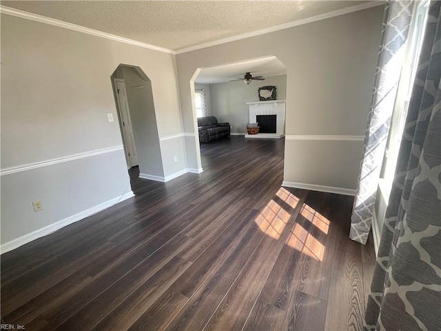 1304 Fernham Ln, Chesapeake, VA 23322 - interior space featuring ceiling fan, a fireplace, arched walkways, a textured ceiling, and dark wood-style floors