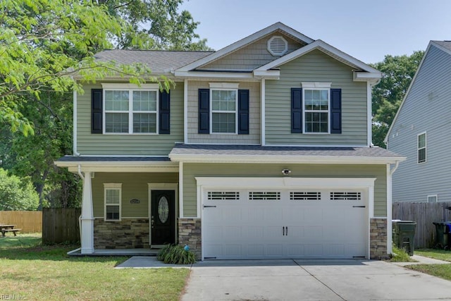 3214 Herbert St, Norfolk, VA 23513 - craftsman-style house with fence, covered porch, stone siding, concrete driveway, and an attached garage