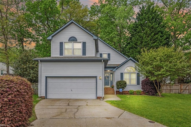 view of front of property with a yard, fence, an attached garage, and driveway