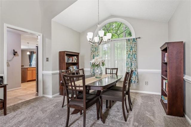 dining space with an inviting chandelier, lofted ceiling, light carpet, baseboards, and light tile patterned floors