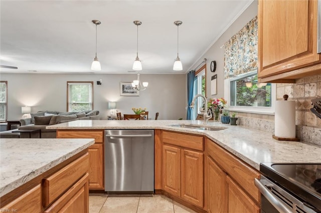 kitchen featuring light stone countertops, plenty of natural light, a sink, and dishwasher