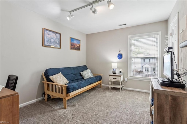 living area featuring visible vents, rail lighting, baseboards, and carpet flooring