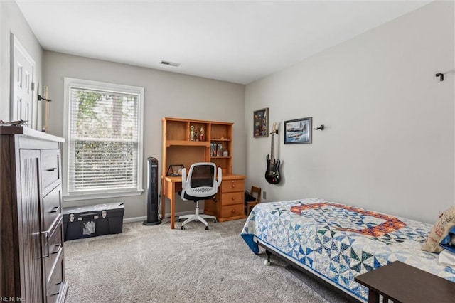 carpeted bedroom featuring baseboards and visible vents