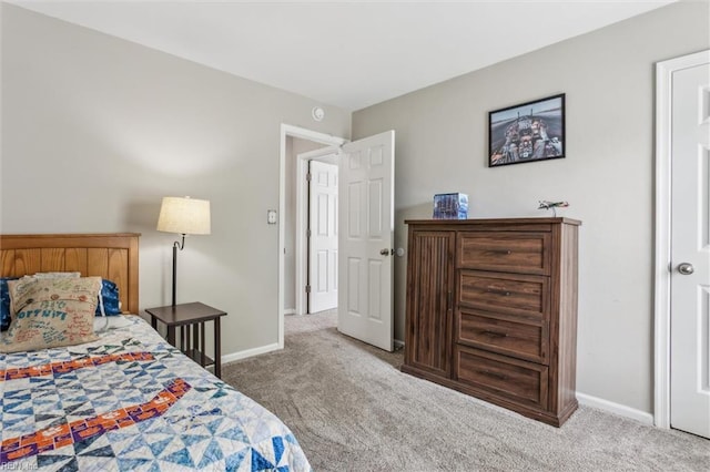 bedroom with carpet floors and baseboards