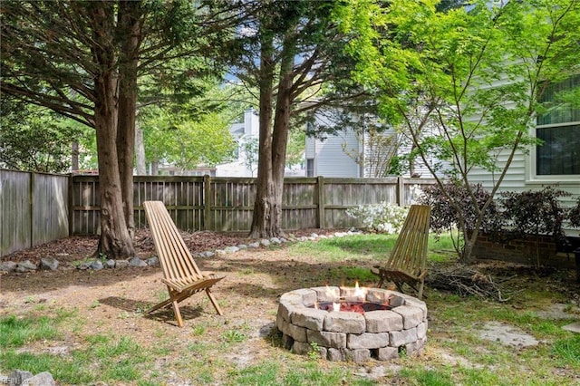 view of yard featuring a fenced backyard and an outdoor fire pit
