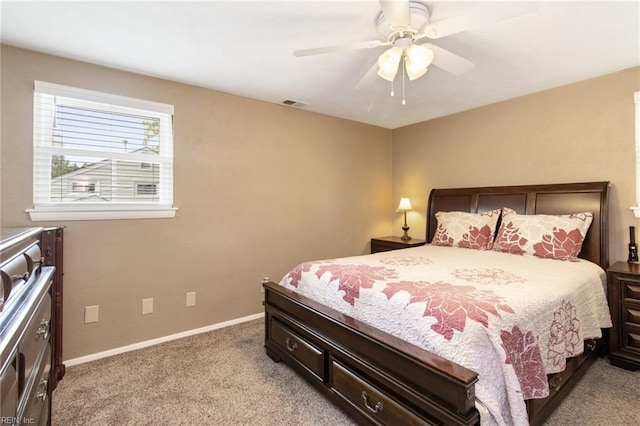 bedroom with light colored carpet, baseboards, visible vents, and a ceiling fan