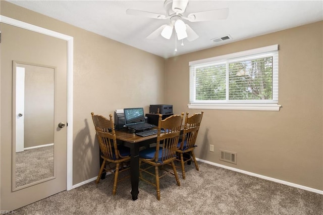 carpeted dining area featuring visible vents, a ceiling fan, and baseboards