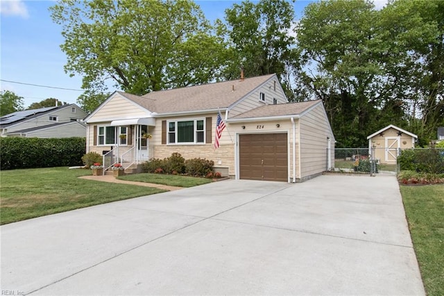 single story home with concrete driveway, fence, a front yard, and a garage