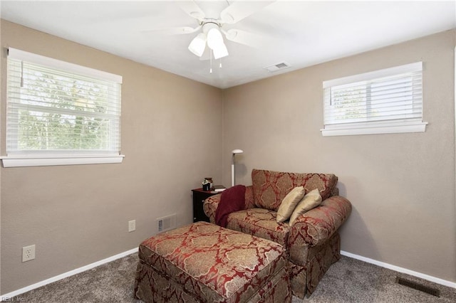 living area with baseboards, carpet flooring, and visible vents