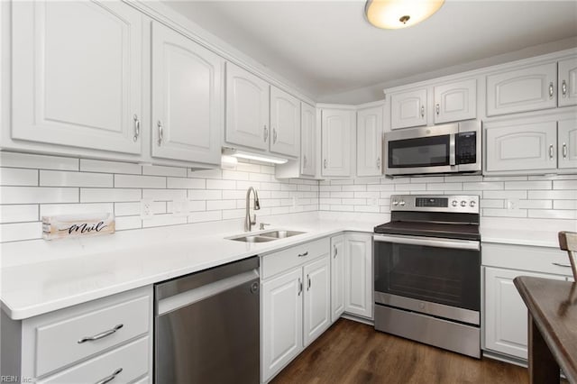 kitchen with a sink, appliances with stainless steel finishes, and white cabinets