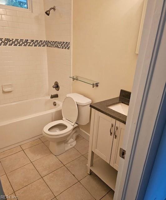 bathroom with tile patterned flooring, baseboards, vanity, toilet, and washtub / shower combination