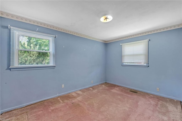 carpeted spare room with baseboards and visible vents