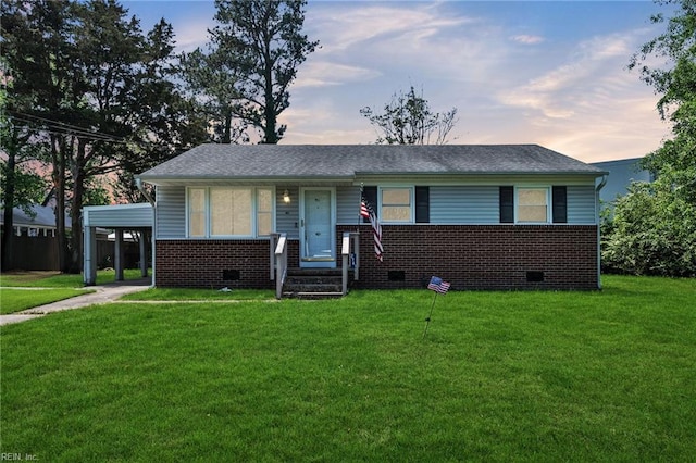 single story home featuring brick siding, crawl space, a front yard, and a carport