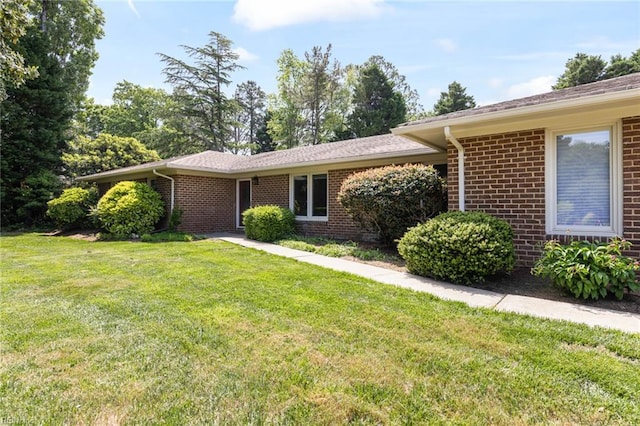 single story home with brick siding and a front lawn