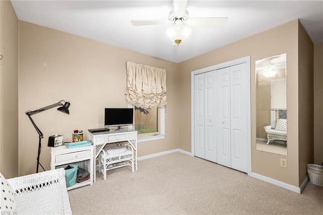 office featuring a ceiling fan, baseboards, and carpet