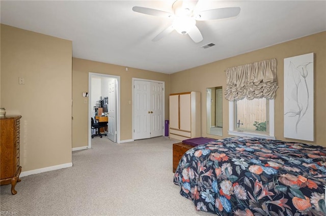 carpeted bedroom featuring baseboards, ceiling fan, and visible vents