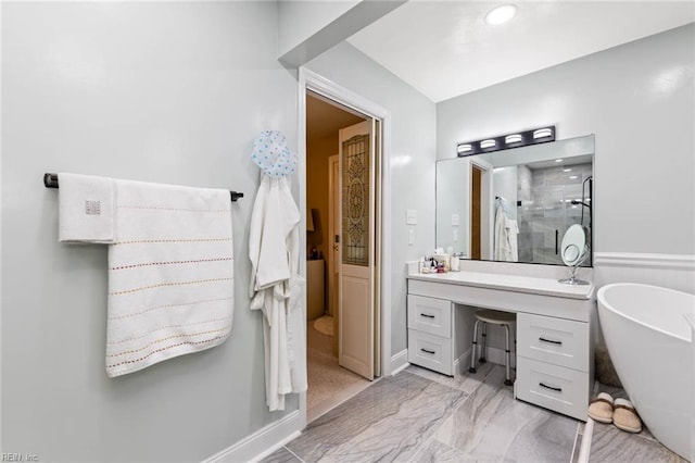 bathroom featuring vanity, marble finish floor, a freestanding bath, and a shower stall