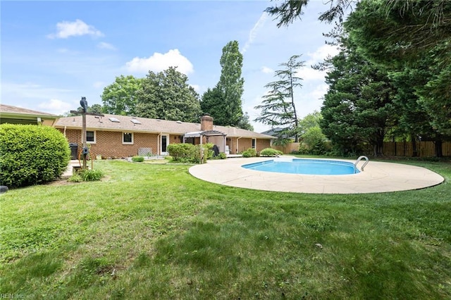 view of pool featuring a lawn, fence, and a fenced in pool