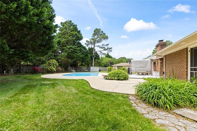 view of yard with a fenced in pool, a fenced backyard, and a patio area