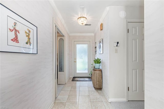 hall featuring crown molding, baseboards, light tile patterned floors, and visible vents