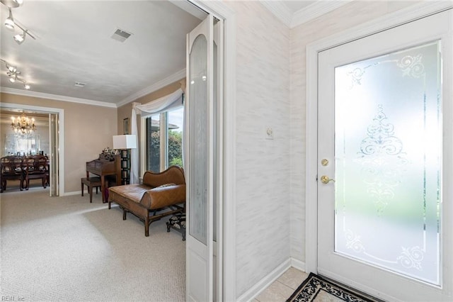 entryway with visible vents, baseboards, crown molding, and a notable chandelier