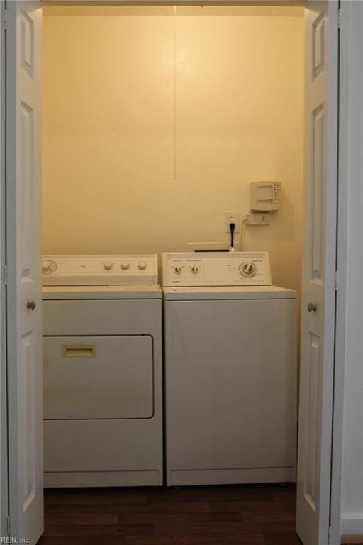 laundry room featuring laundry area, dark wood-style floors, and washer and dryer