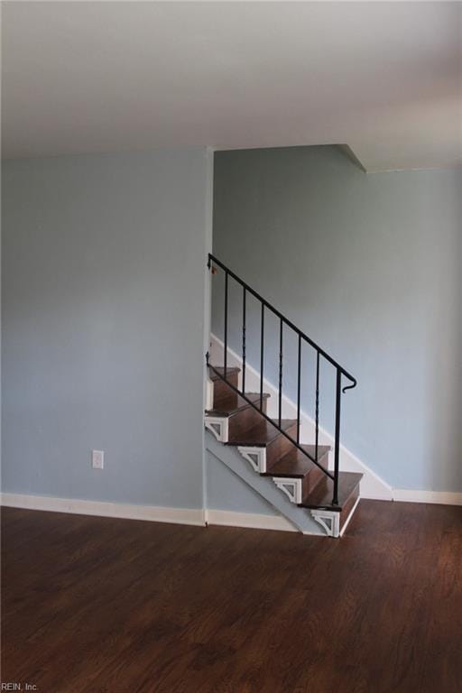 stairs featuring baseboards and wood finished floors