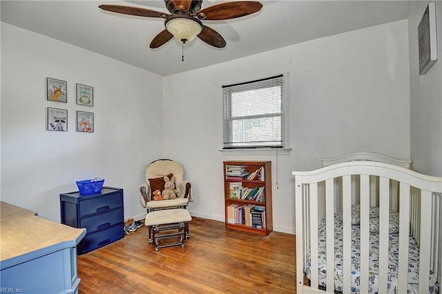 bedroom featuring a ceiling fan and wood finished floors
