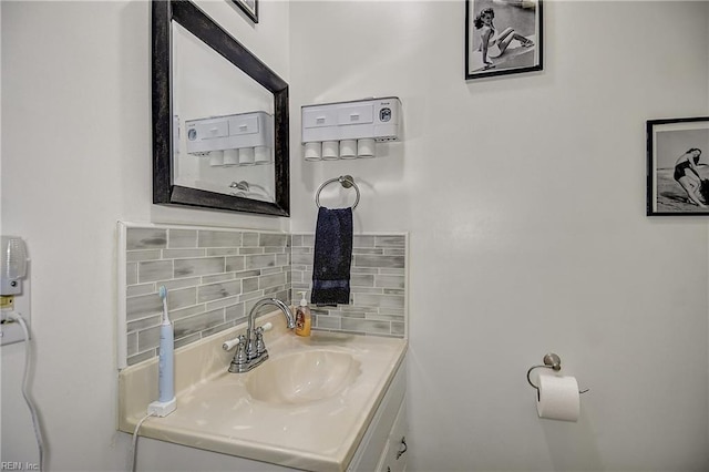 bathroom with vanity and tasteful backsplash