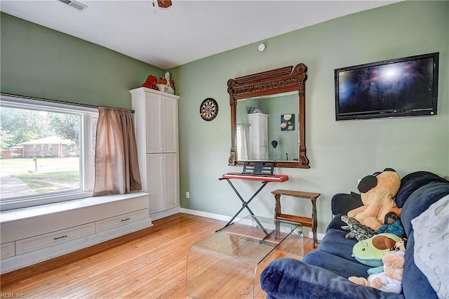 interior space with baseboards and light wood finished floors