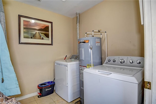 washroom with laundry area, washing machine and dryer, light tile patterned flooring, and electric water heater