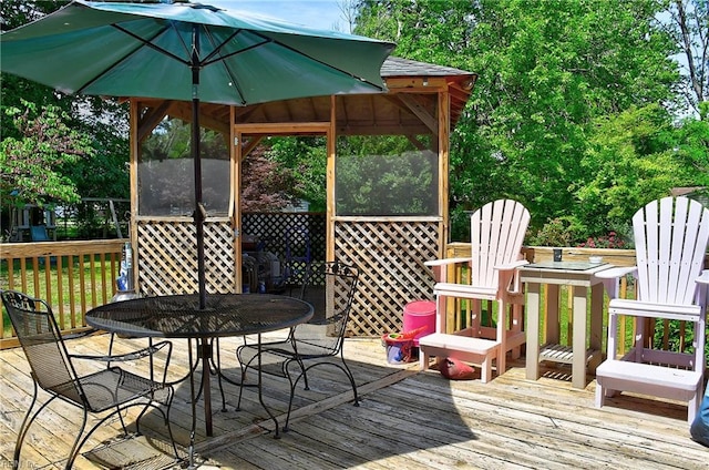 wooden terrace featuring outdoor dining area